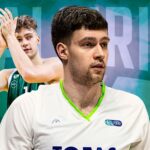 Two basketball players on a teal geometric backdrop: a foreground player in a white jersey with lime trim, and a green-jersey teammate clapping behind him.