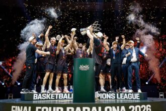 Basketball team celebrating on a podium with a trophy as confetti falls after winning Final Four Badalona 2026.