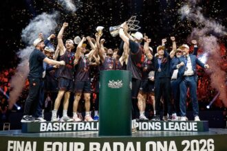 Basketball team celebrating on a podium with a trophy as confetti falls after winning Final Four Badalona 2026.