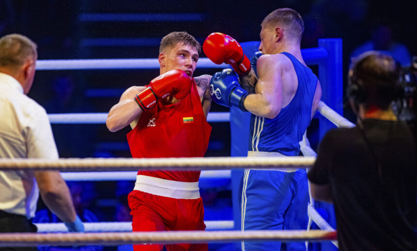 Red boxer lands a punch on the blue opponent in the ring during a boxing match.