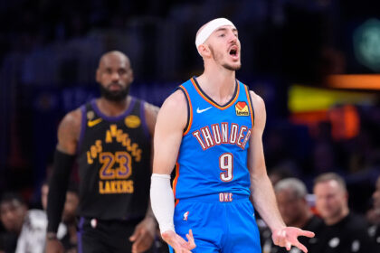 Thunder player wearing a blue OKC jersey with number 9, shouting with arms outstretched on a basketball court, Lakers opponent in background.”]} Wait need multiple options. Let's correct format. Provide array of strings. Let's craft three options.