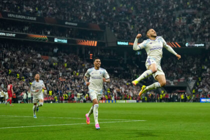 Aston Villa players in white celebrate on the pitch as one jumps in the air during a Europa League match, full stadium in the background.]','A jumping Villa player celebrates a goal with teammates and a cheering crowd in a packed stadium.','Footballers in white kits celebrate a goal on the field amid a large, enthusiastic crowd.','Group of Aston Villa players in white jerseys celebrate a moment on the pitch during a Europa League game.','Excited players celebrate a goal on the soccer field while fans cheer in the stands.