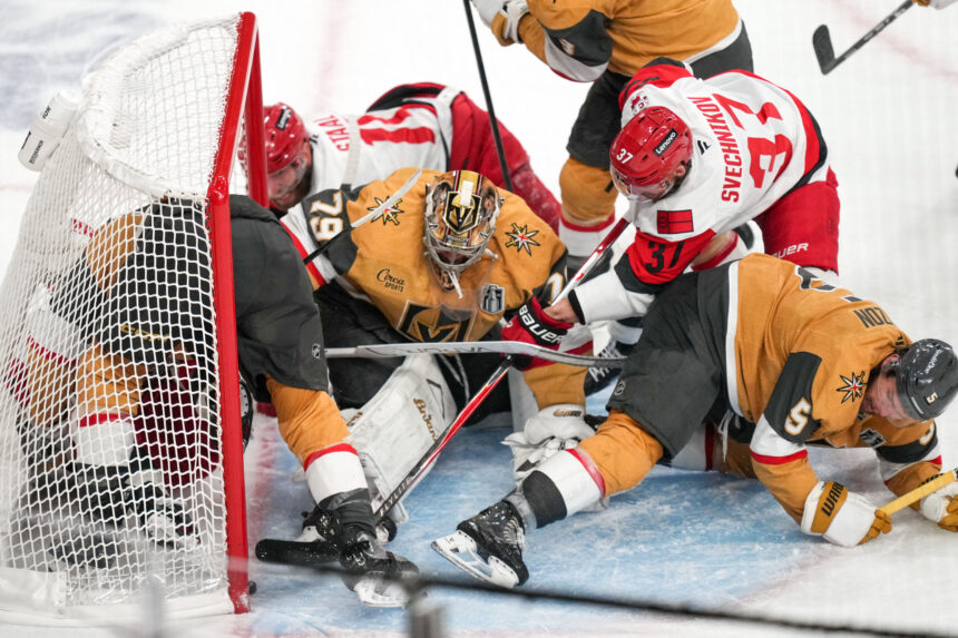 Hockey players collide near the goal net during a scramble for the puck on an ice rink
