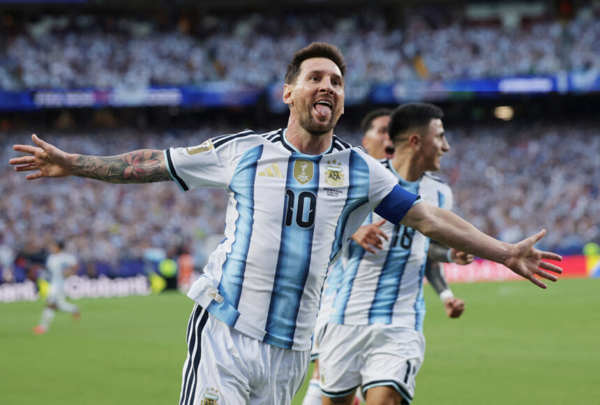 Argentinian soccer player celebrating with arms wide on the field in a blue-and-white striped jersey (number 10).