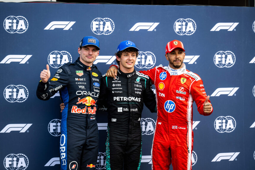 Three Formula 1 drivers pose on a podium with a FIA/F1 backdrop, from left Verstappen, Russell, and Leclerc.