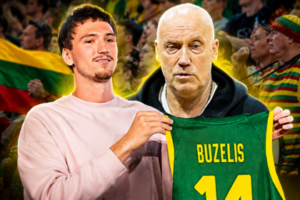 Two sports fans pose together; a pink-shirted man holds a green BUZELIS 14 jersey in front of a cheering crowd.