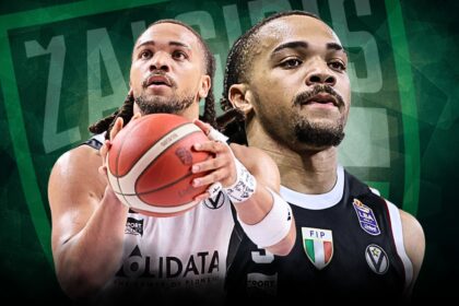 Two basketball players tightly framed, one in a white jersey and the other in a black jersey, reach for a basketball against a dark green geometric background with team logos nearby.