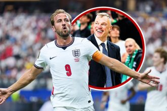 England footballer in white jersey (#9) celebrates with arms outstretched on the field, crowd in the background, framed by a red circle.