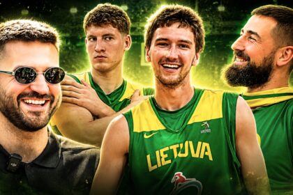 Group of smiling male basketball players in green-yellow Lithuania jerseys posing together, celebrating victory.