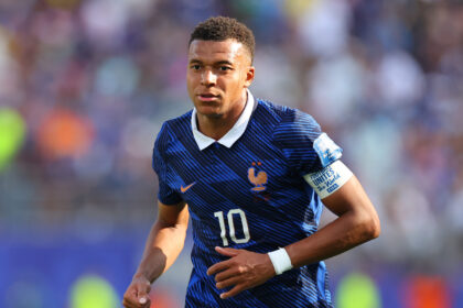 France national team footballer in a blue kit, number 10, running on the pitch during a match.