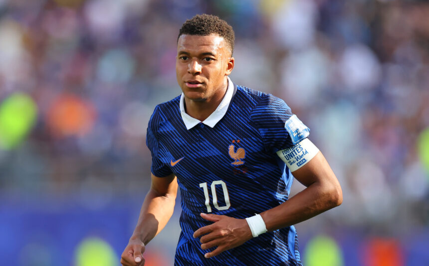 France national team footballer in a blue kit, number 10, running on the pitch during a match.