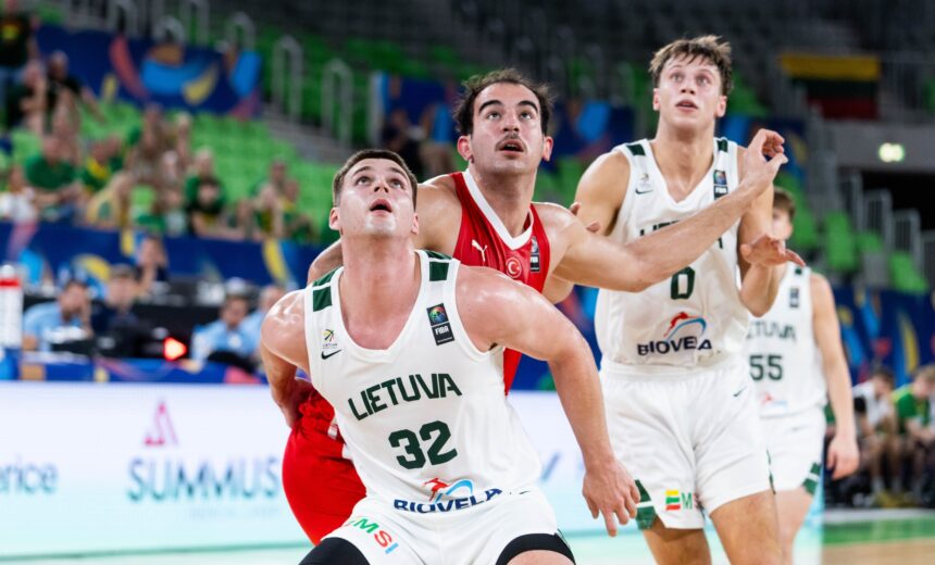 Lithuania national basketball players in white jerseys reach upward during a game as green arena seats and crowd loom in the background, #32 in front.