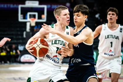 Two Lithuanian basketball players scrabble for the ball in white uniforms, one being defended by a dark-clad opponent near the hoop area.