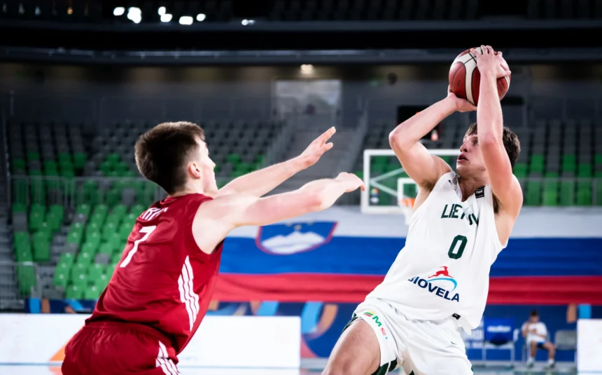 Basketball player in white drives toward the hoop while defended by a red-team defender nearby