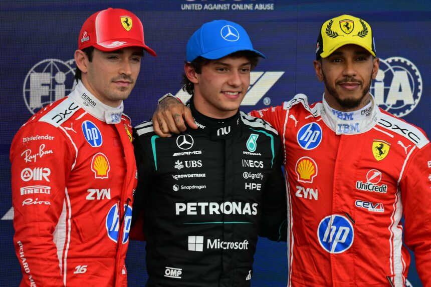 Three Formula 1 drivers pose on a podium: left and right wear red Ferrari suits, center in a black Mercedes Petronas suit with arms around each other; backdrop shows sponsor logos and 'United Against Online Abuse' text.